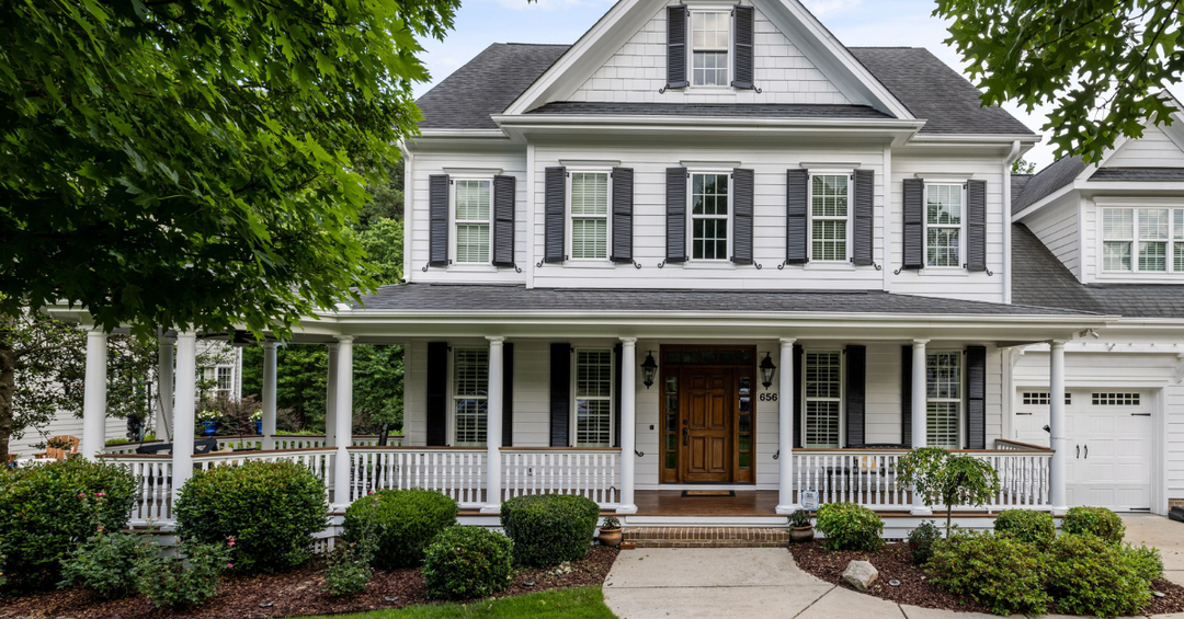 Foundation planting with hydrangeas, evergreen shrubs, and boxwoods around a home
